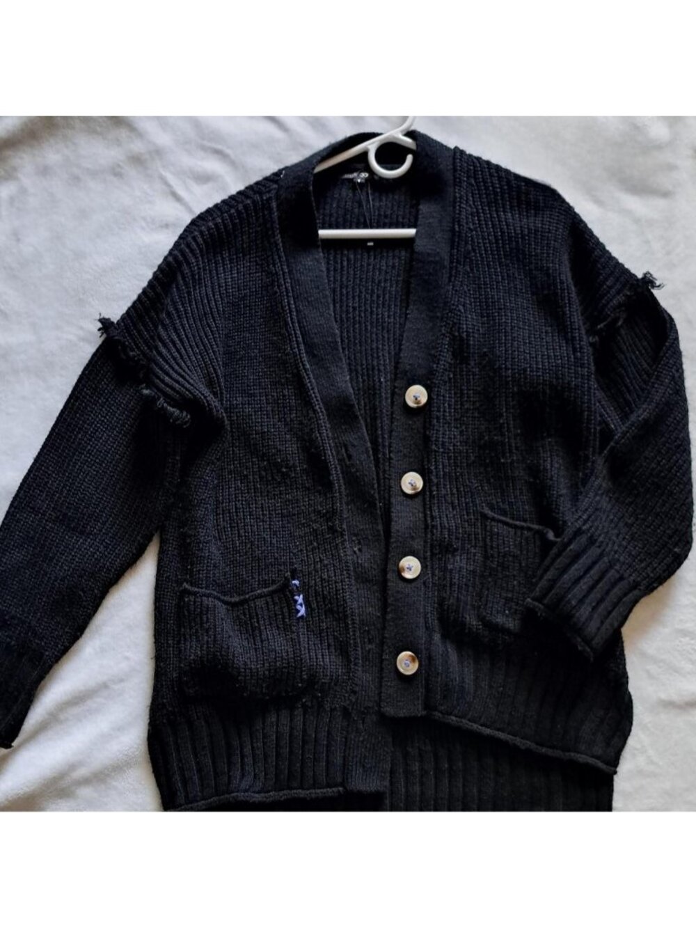 oversized black knit cardigan distressed with blue accents papermoon